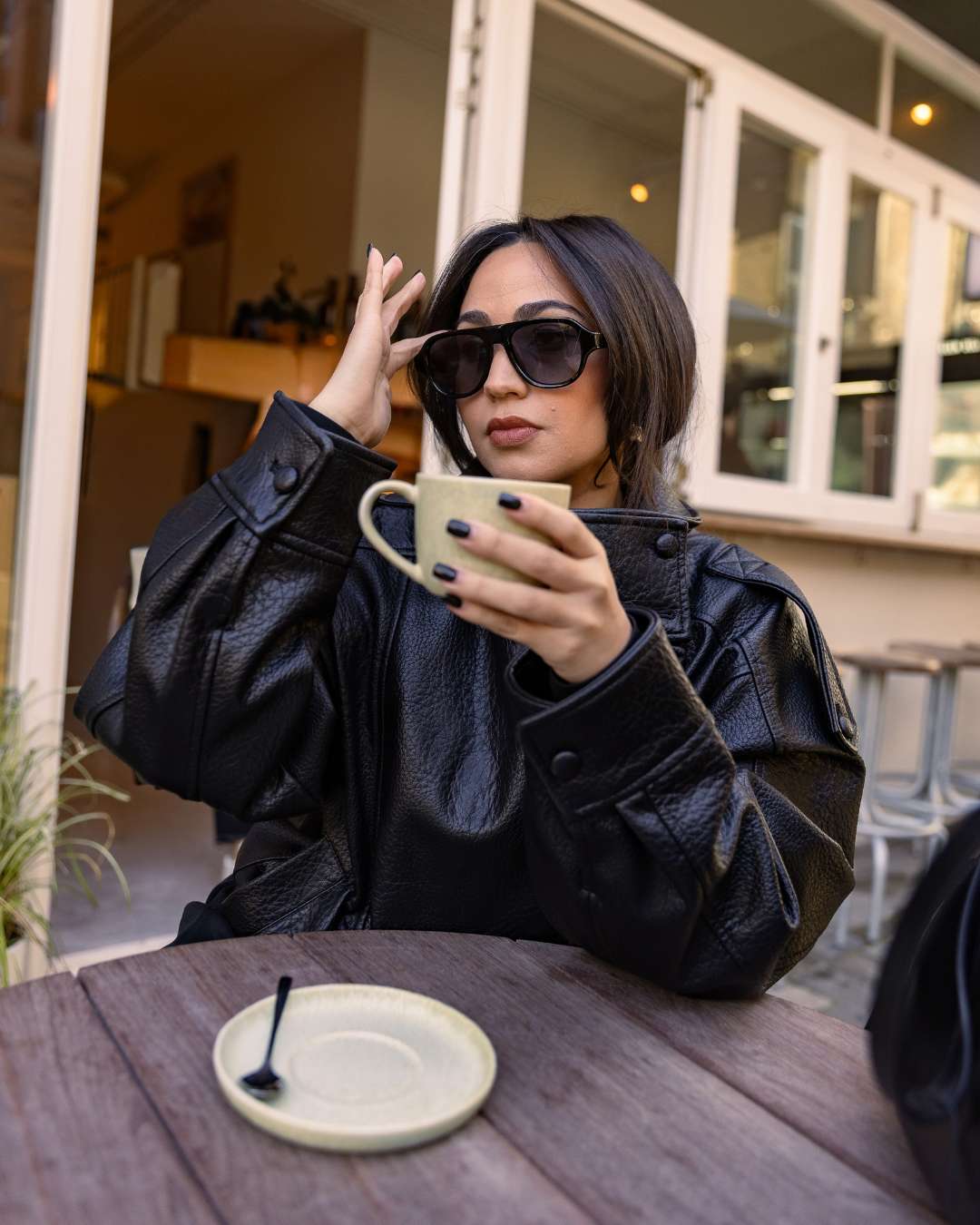 woman wearing polarised aviator sunglasses with black acetate frames and gradient lenses