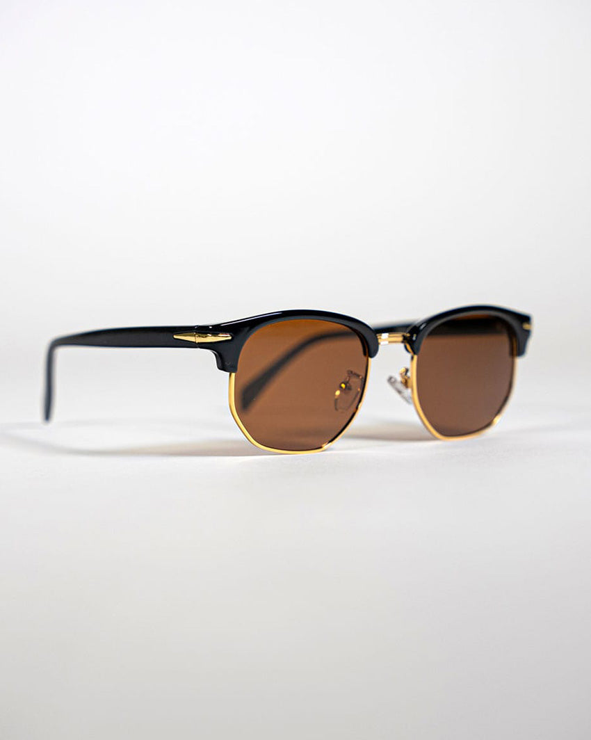 side view of polarised square sunglasses with black and gold frames and brown lenses