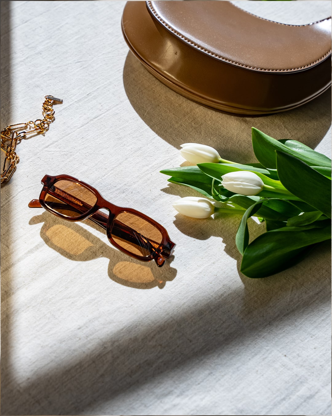flat lay of brown rectangular sunglasses with brown lenses