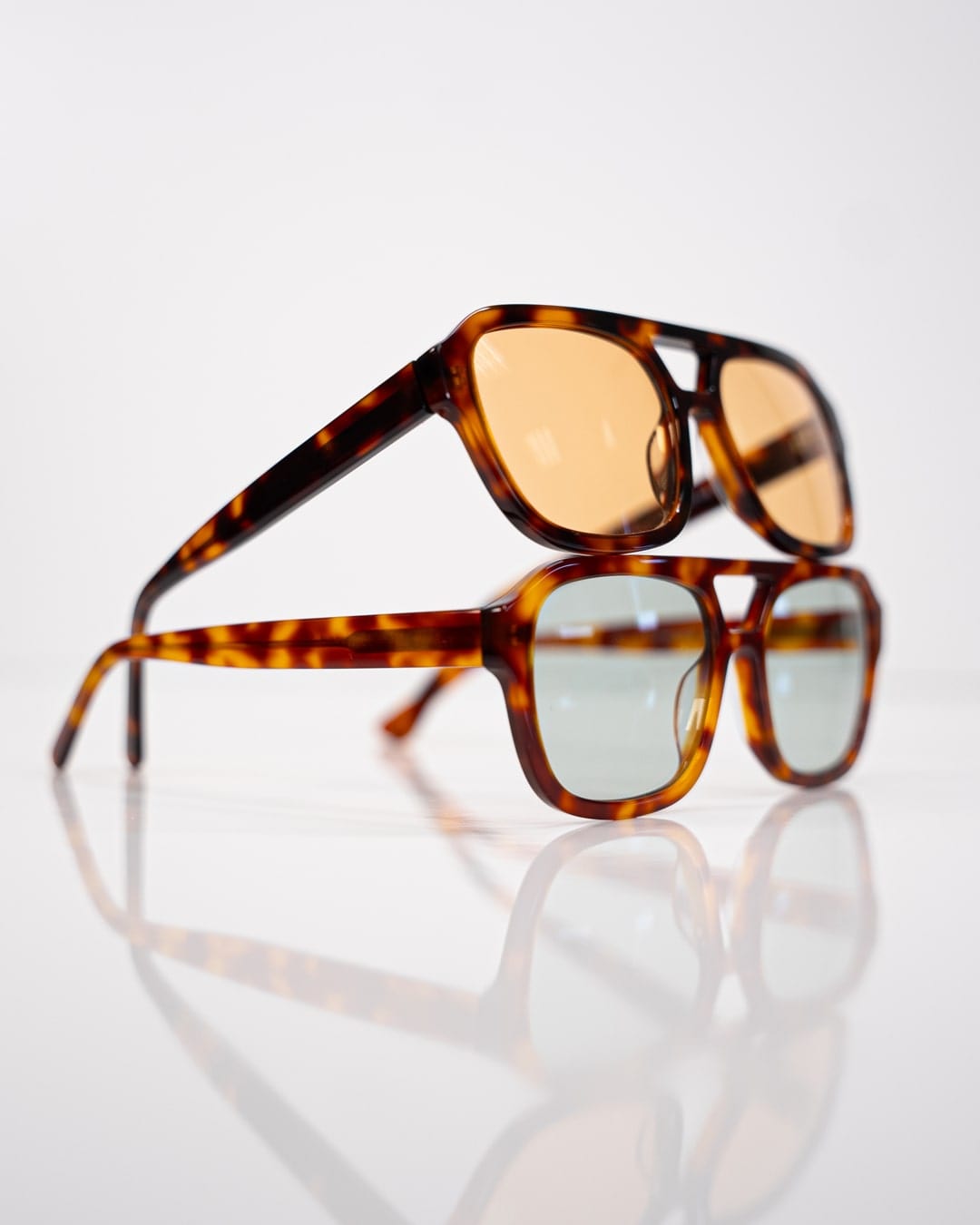 two pairs of stacked rectangular aviator sunglasses with tortoiseshell acetate frames