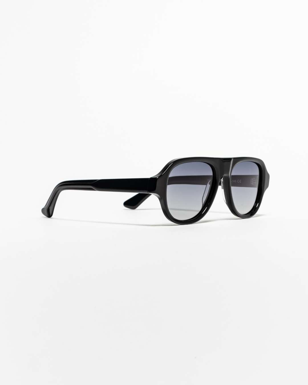 side view of polarised aviator sunglasses with black acetate frames and gradient lenses