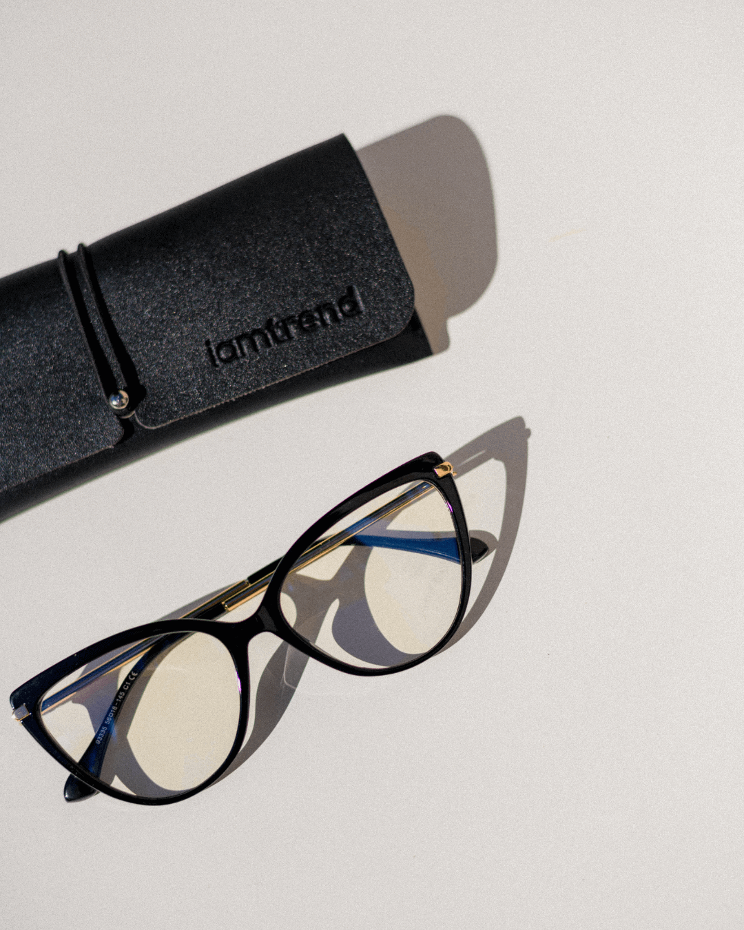 cat-eye blue light blocking glasses with a black frame and gold temples and protective case