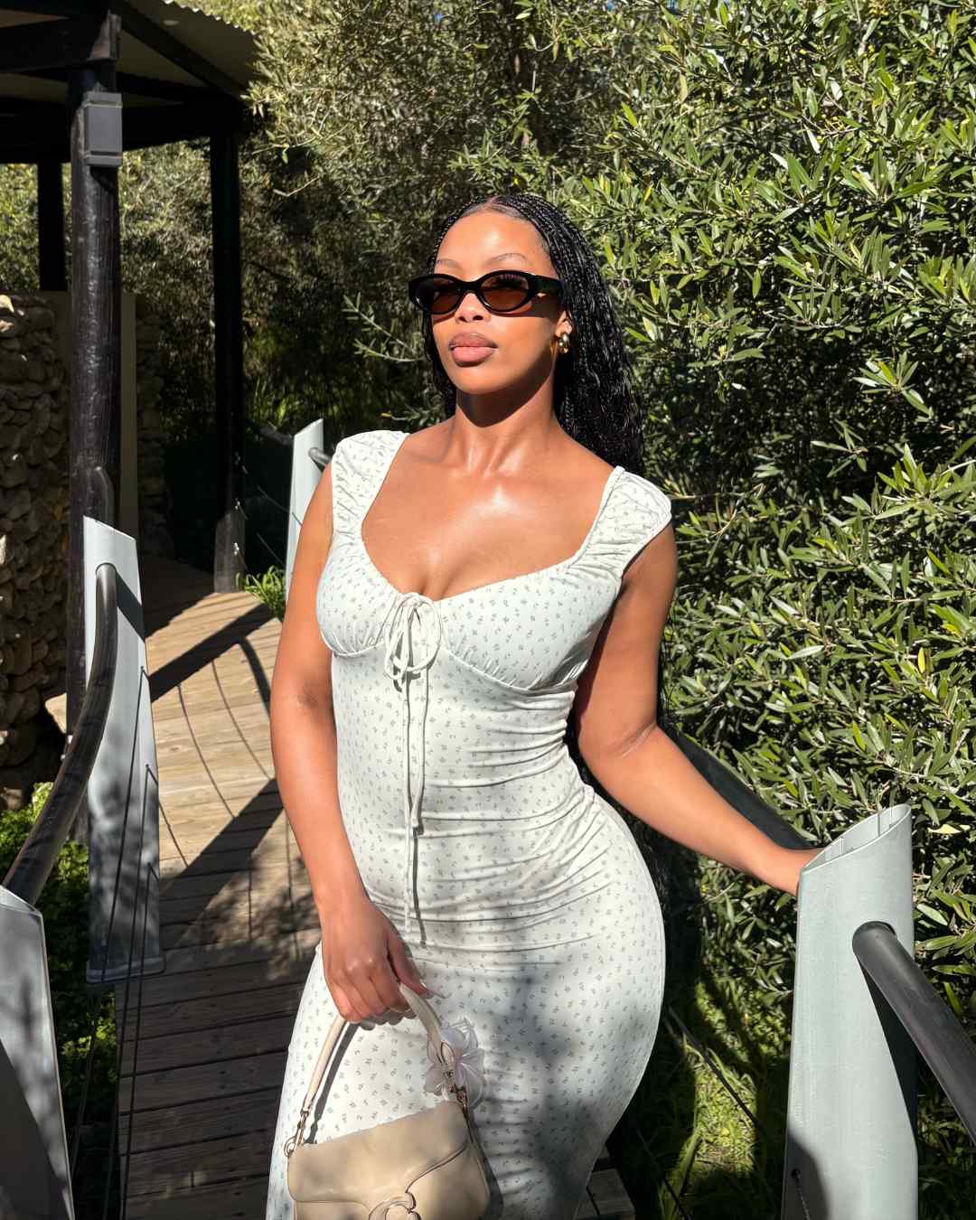 woman wearing oval polarised sunglasses with black frames and brown lenses