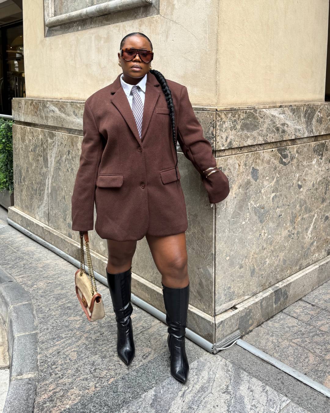 woman wearing oversized shield sunglasses with tortoiseshell frames and brown gradient lenses