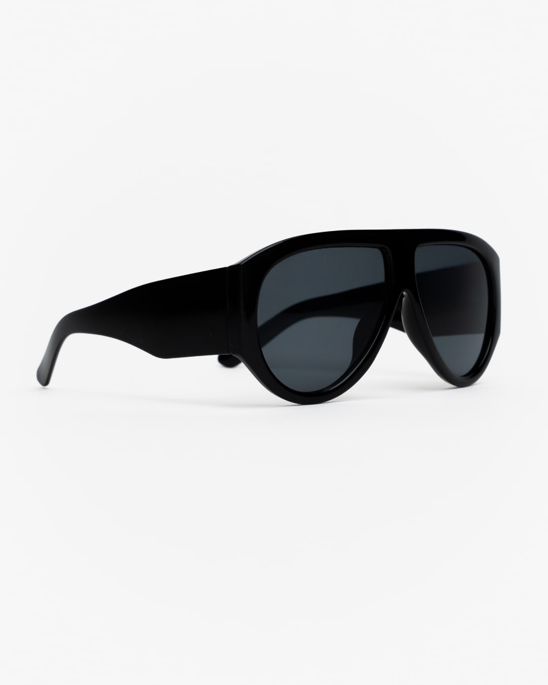 side view of oversized shield sunglasses with jet black frames and black lenses