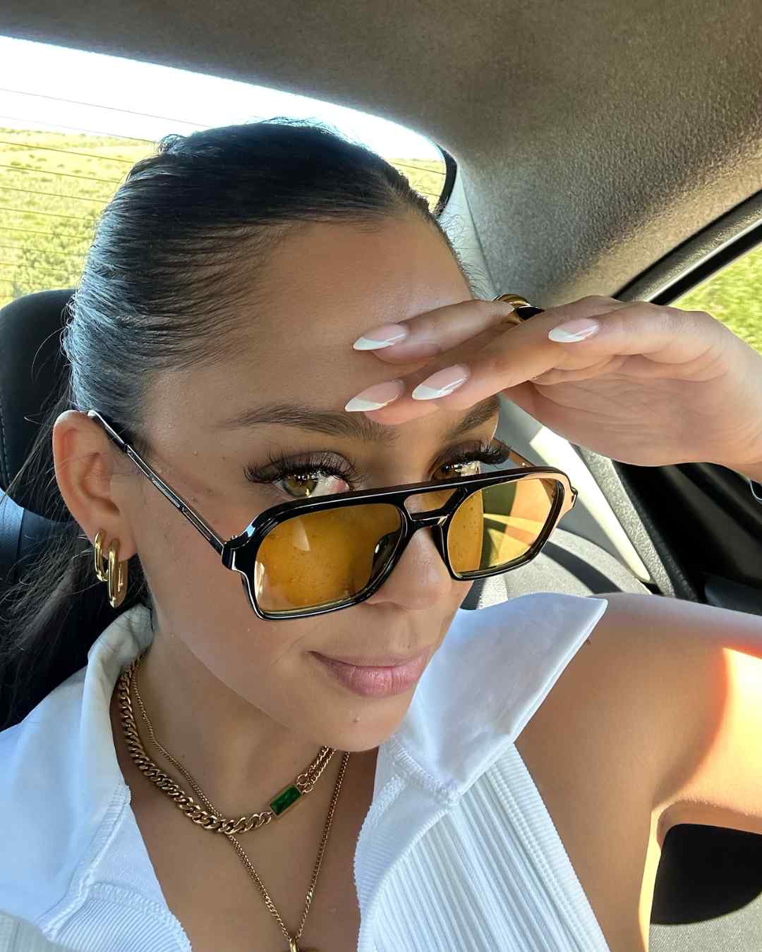 woman wearing aviator sunglasses with polarised yellow-tinted lenses