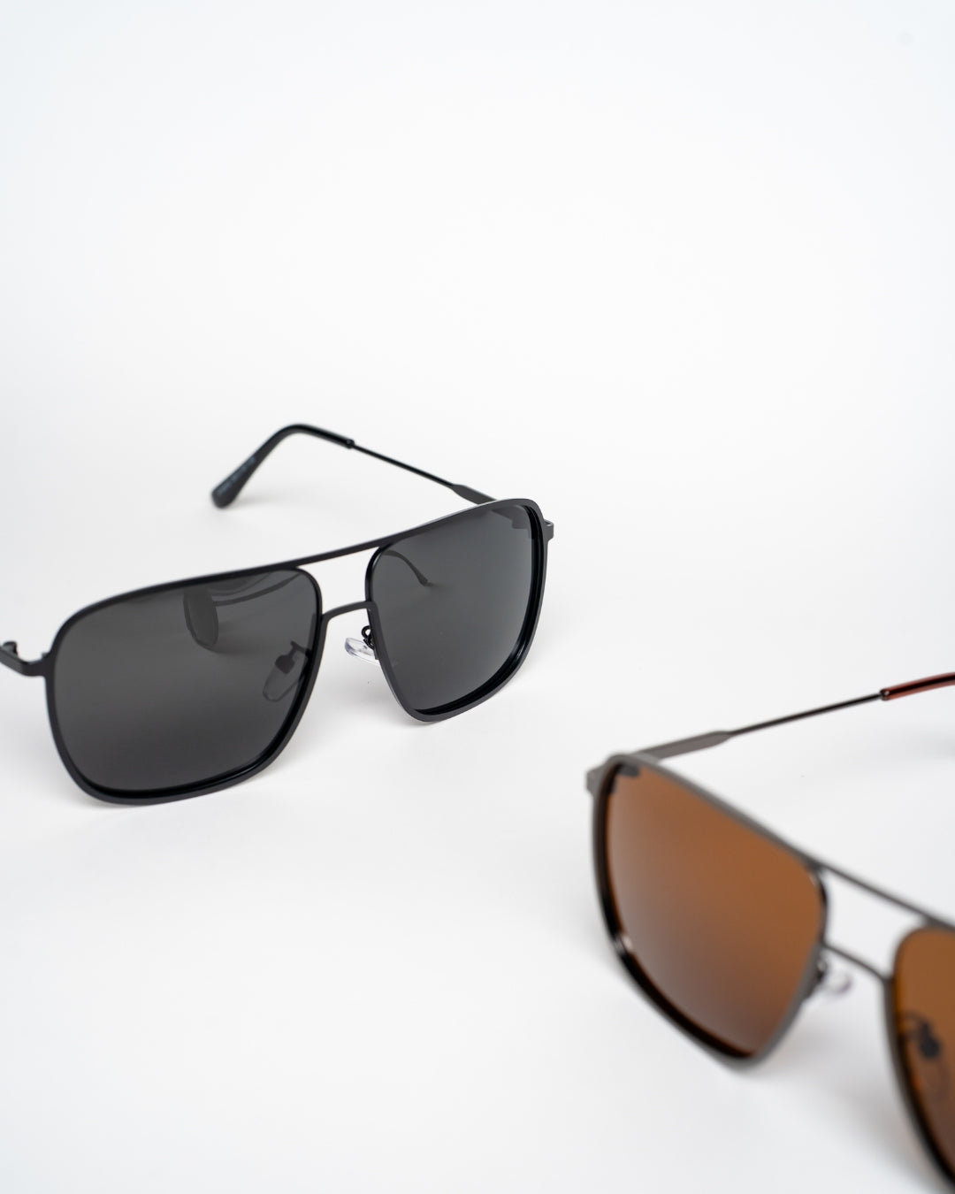 angled view of black and brown square aviator sunglasses