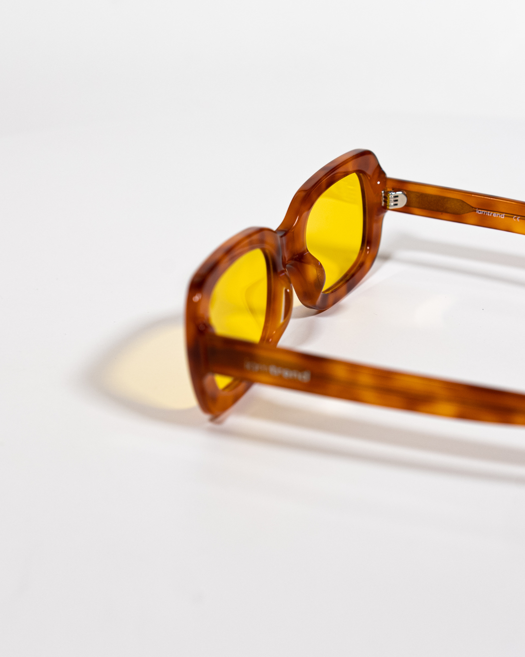 close-up of rectangular polarised sunglasses with amber acetate frames