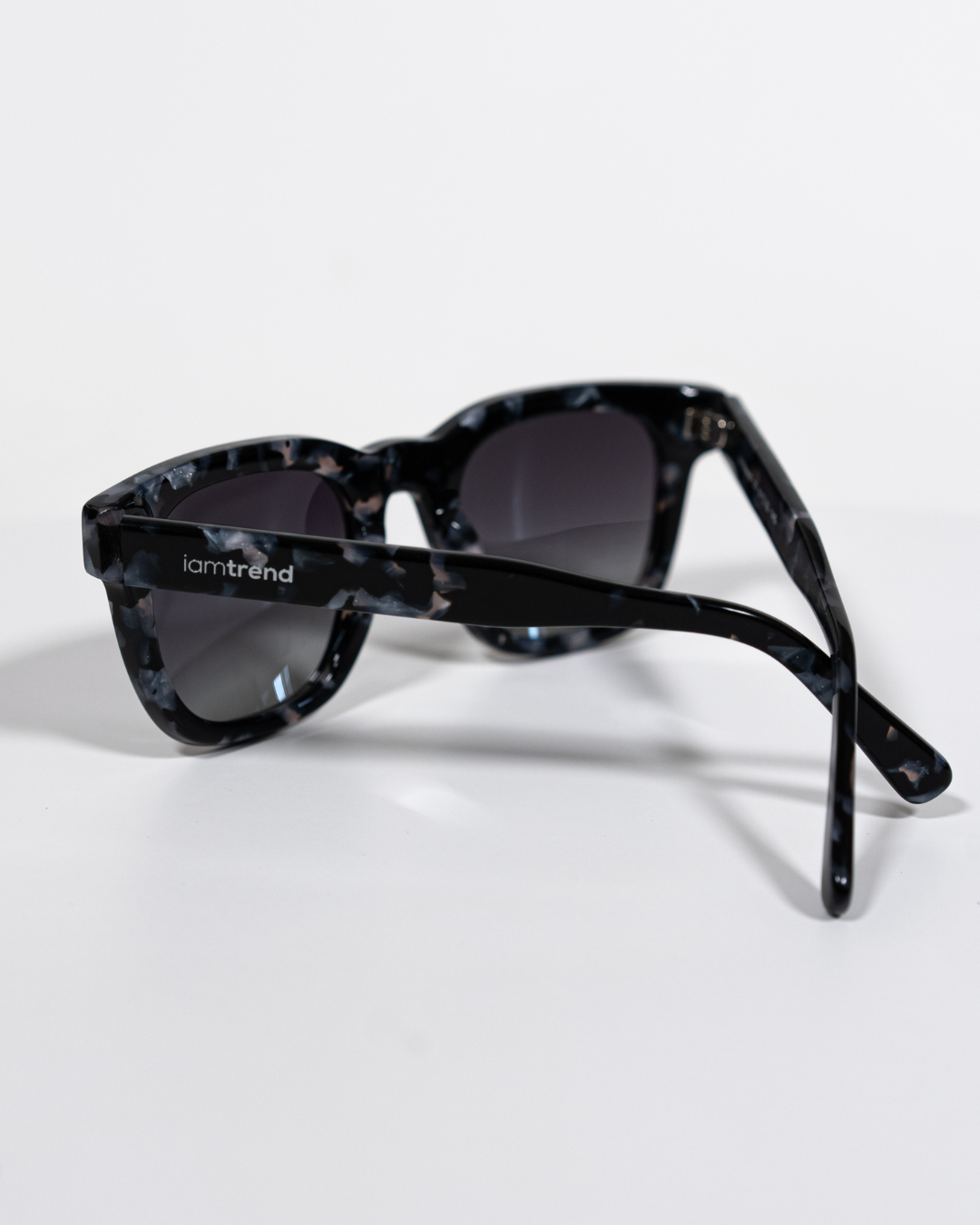 angled view of square polarised sunglasses with black acetate frames and gradient lenses