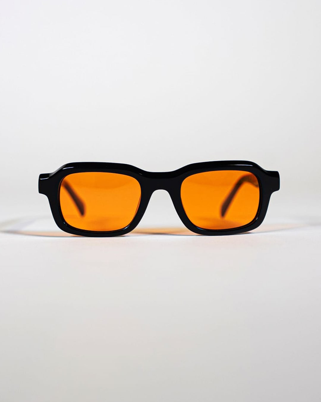 black rectangular sunglasses with orange lenses