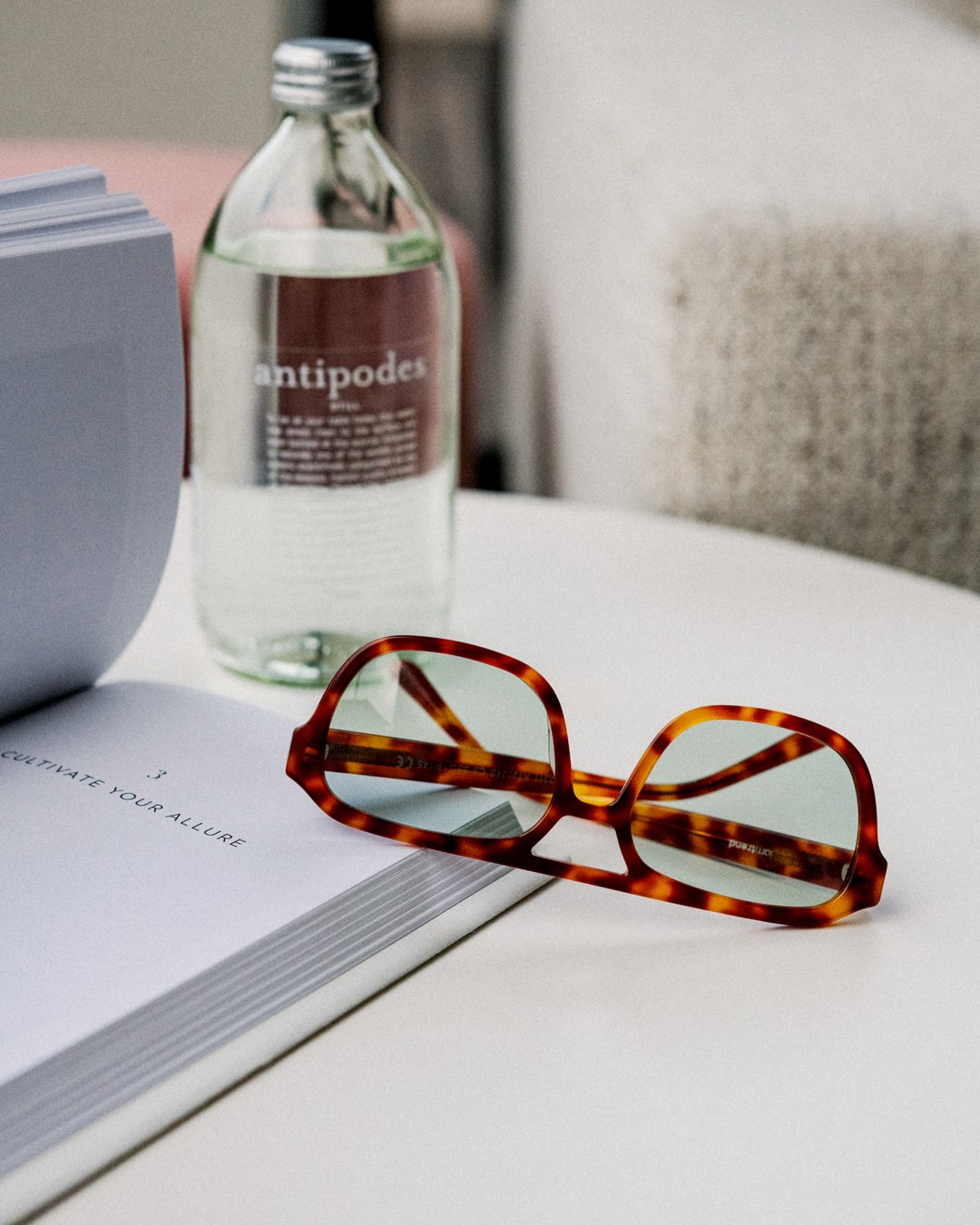rectangular aviator sunglasses with tortoiseshell acetate frames on a notebook