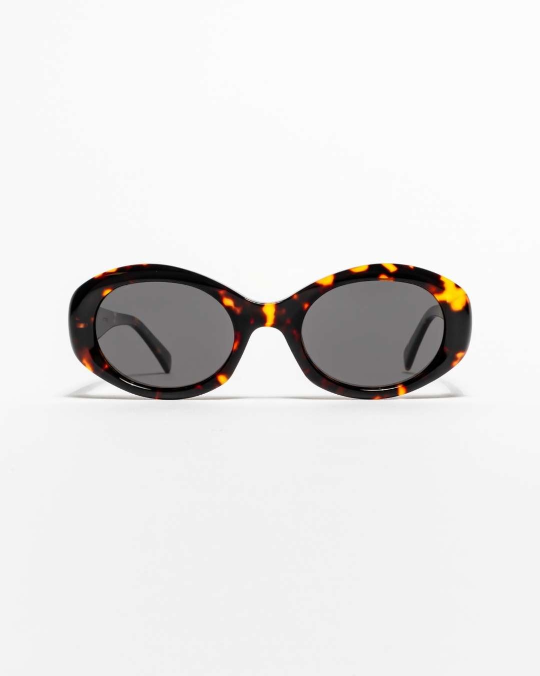 sunglasses with tortoiseshell frame and dark lenses on a white background