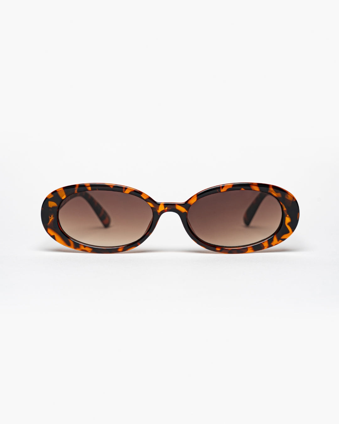 slim oval sunglasses with tortoiseshell frames and brown gradient lenses