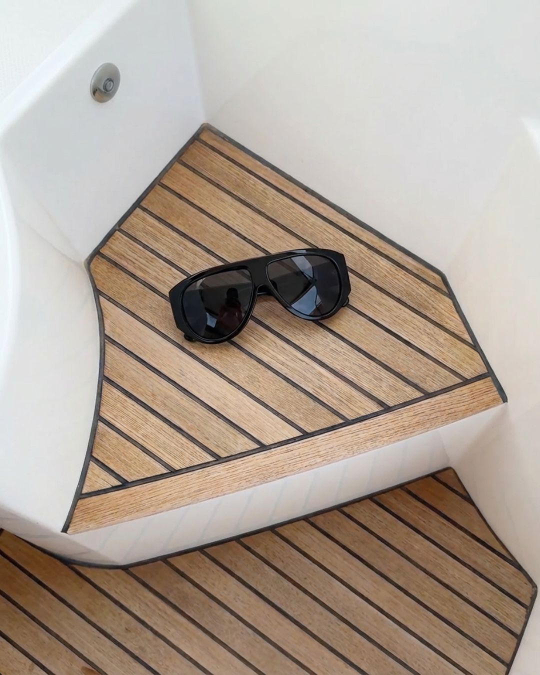 flat lay of oversized shield sunglasses with jet black frames and black lenses